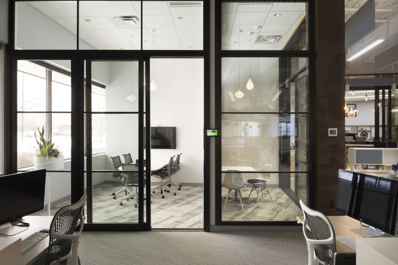 Side by side conference rooms with video conference technology