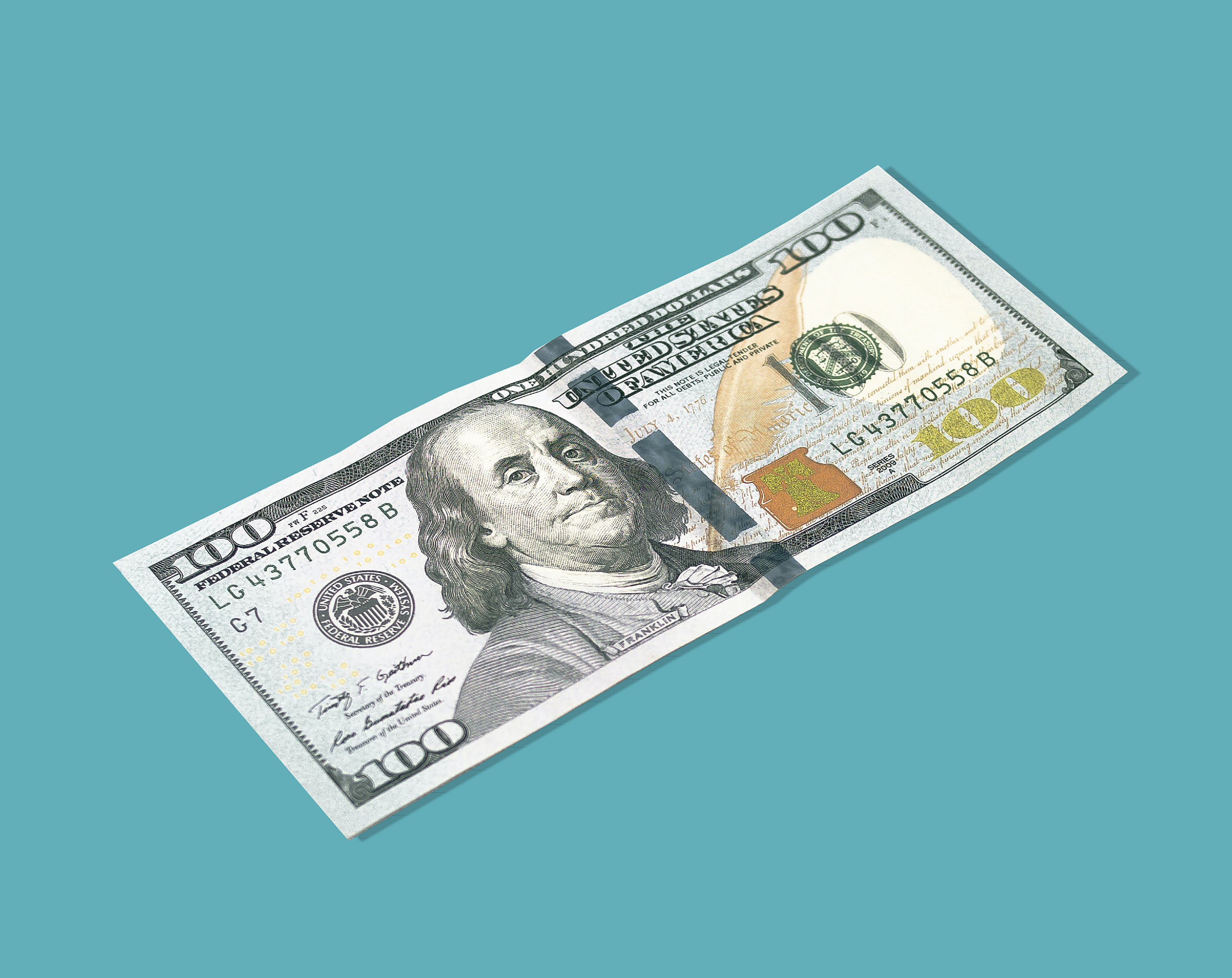 A crisp $100 bill against a teal background, featuring Benjamin Franklin's portrait and security features highlighting U.S. currency design.