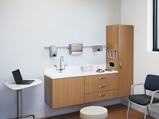 Patient exam room with Oak cabinetry, white surface, a mobile table, two dark Verus side chairs with a Nemschoff Riva bench, and a physician's stool