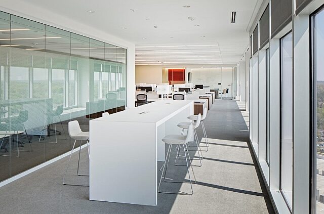 Glass Symbio walls define this modern workspace, allowing natural light to flow freely while maintaining a sleek and professional open-office environment